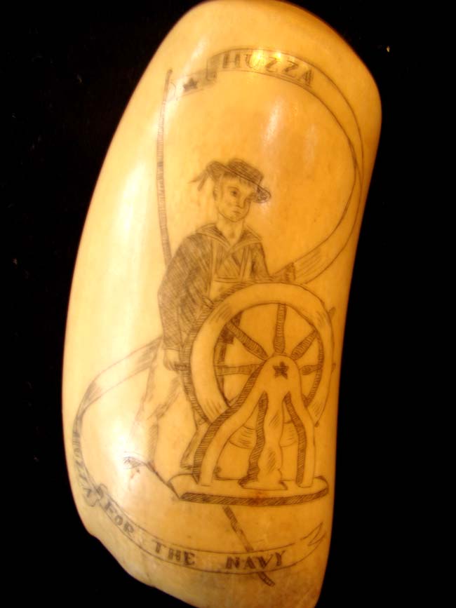 An attractive late 19th or early 20th century scrimshawed whale's tooth with US Navy theme
